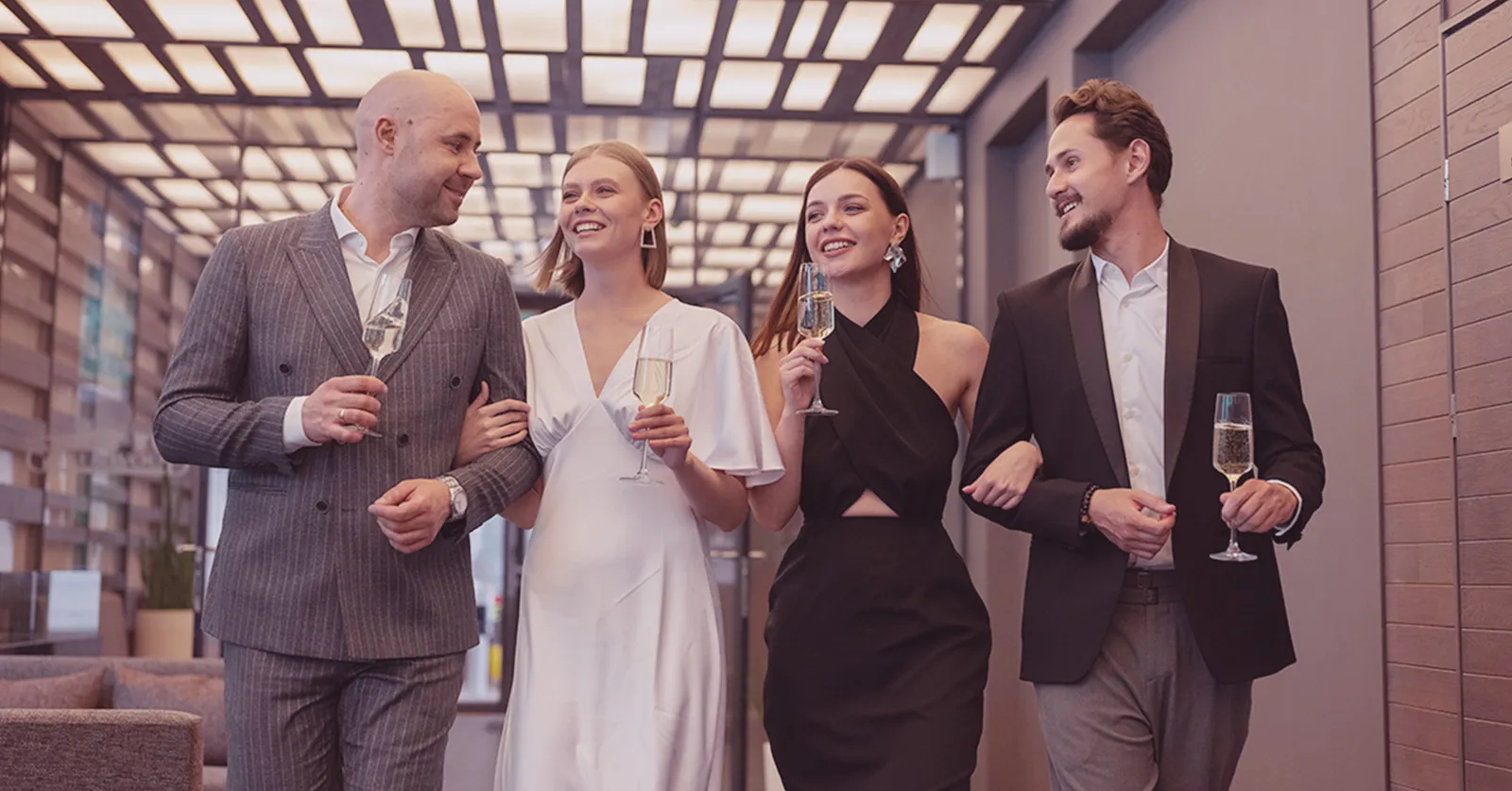 Elegant group in formal attire with champagne, symbolizing our online ticket sales campaign case study.