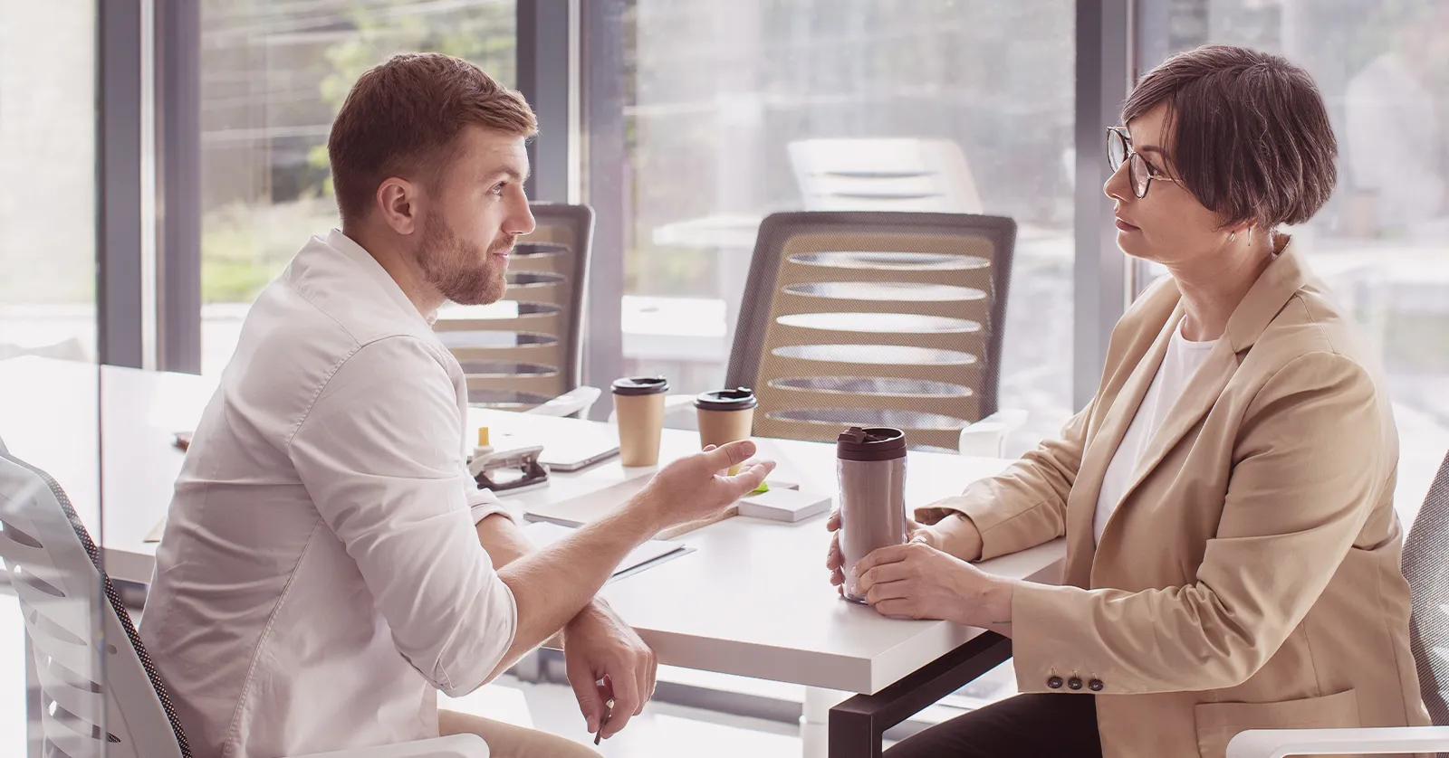 Salesperson consulting with a client at a desk, symbolizing our high-value lead generation success story.